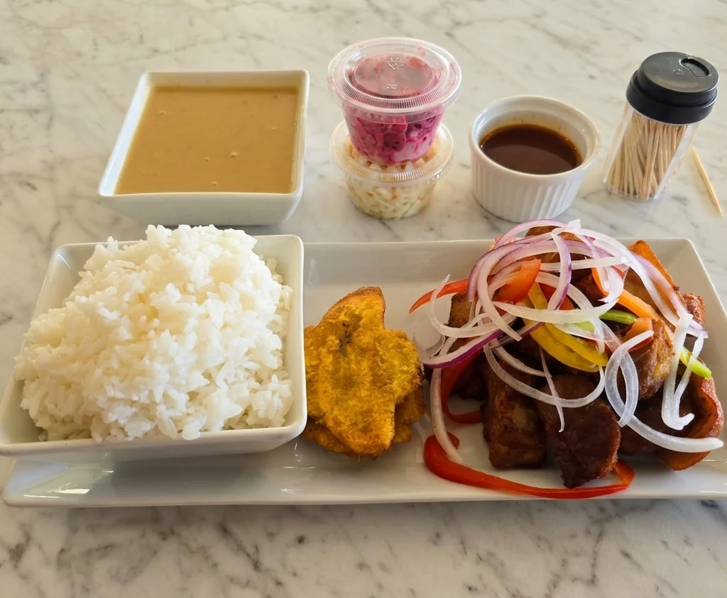 Fried meat plate with griot, rice and spicy coleslaw at Caribbean Latino Finger Licking Restaurant Edmonton