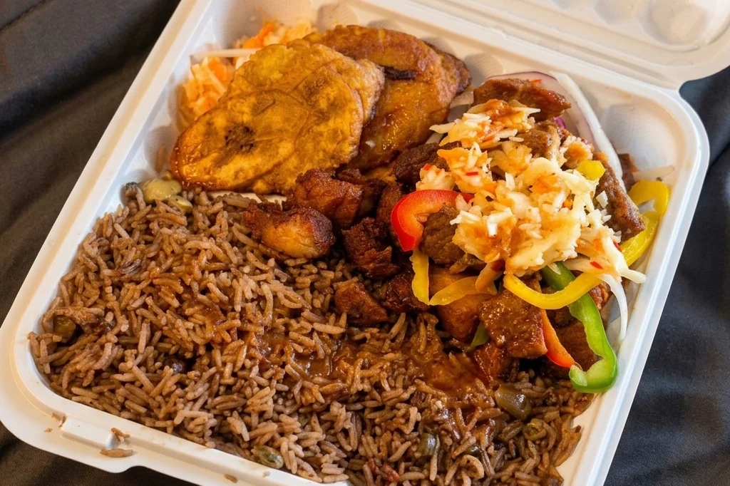 Fried meat plate with griot, rice, plantain and spicy coleslaw at Caribbean Latino Finger Licking Restaurant Edmonton